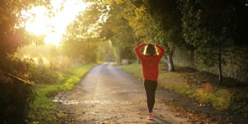 woman walking on pathway during daytime