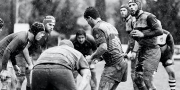 grayscale photo of group of people on football field