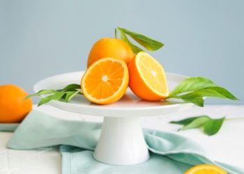 orange fruit in white ceramic plate close-up photography