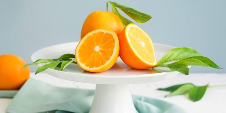 orange fruit in white ceramic plate close-up photography